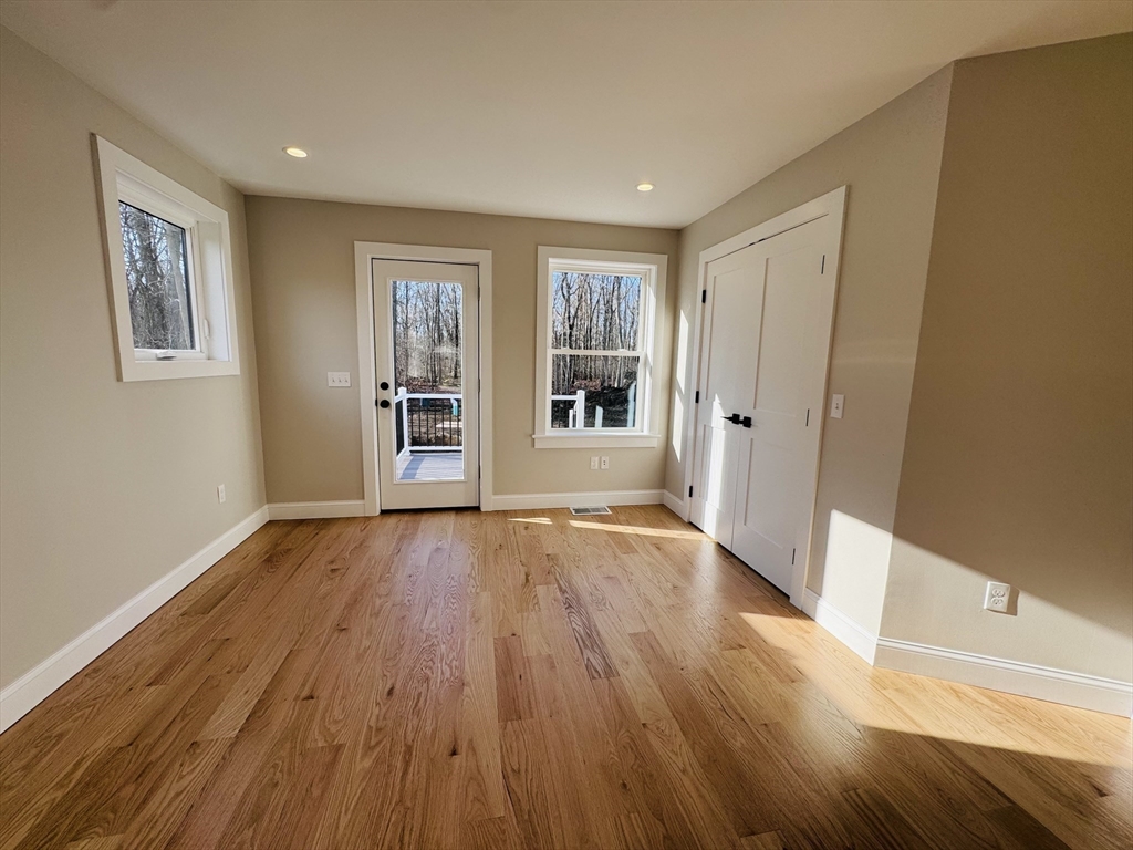 329 Tickle Road Westport, MA 02790 - Photo 20 of 42 a view of an empty room with wooden floor and windows