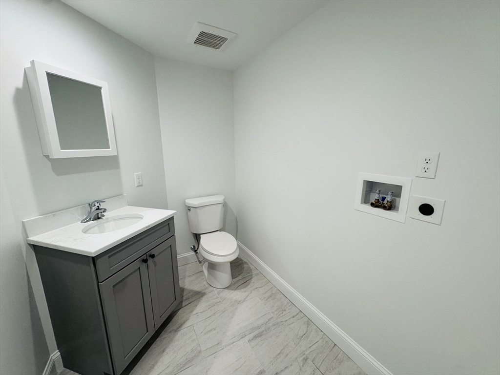 329 Tickle Road Westport, MA 02790 - Photo 21 of 42 a bathroom with a sink toilet and mirror