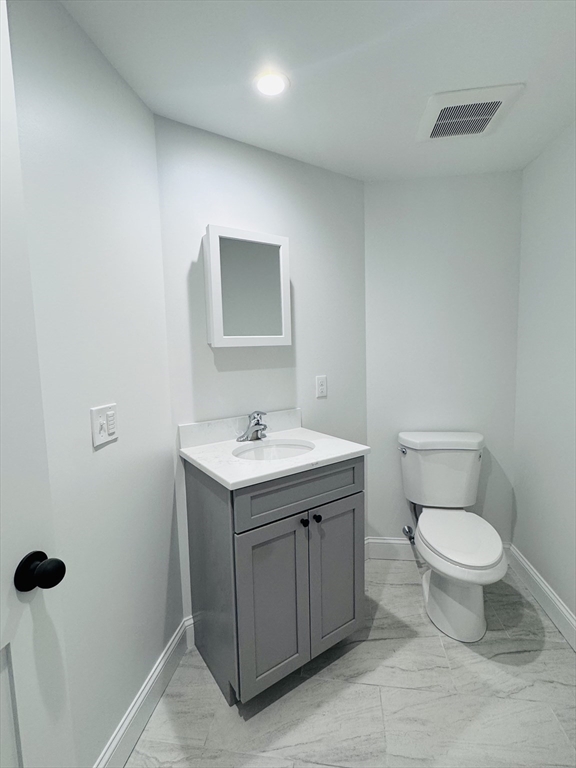 329 Tickle Road Westport, MA 02790 - Photo 22 of 42 a bathroom with a toilet sink and mirror