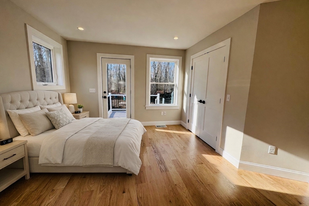 329 Tickle Road Westport, MA 02790 - Photo 23 of 42 a spacious bedroom with a bed and wooden floor