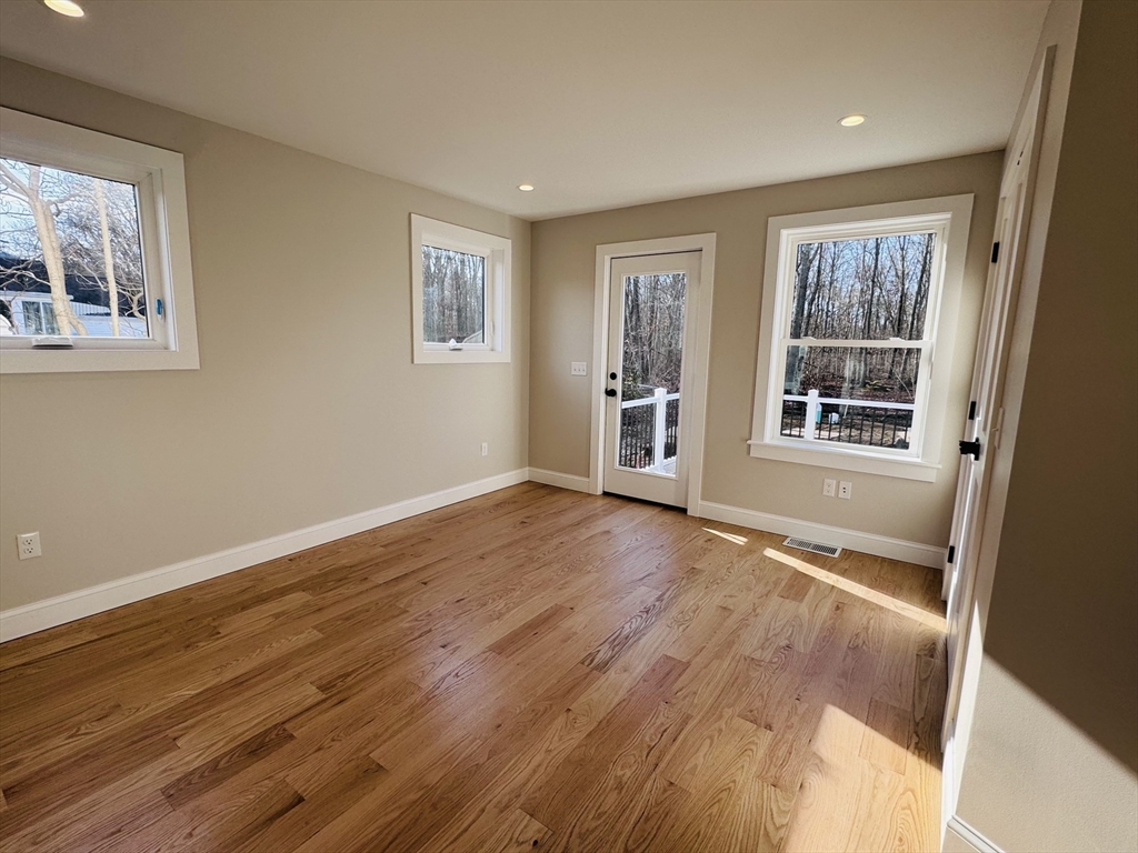 329 Tickle Road Westport, MA 02790 - Photo 24 of 42 a view of an empty room with wooden floor and a window