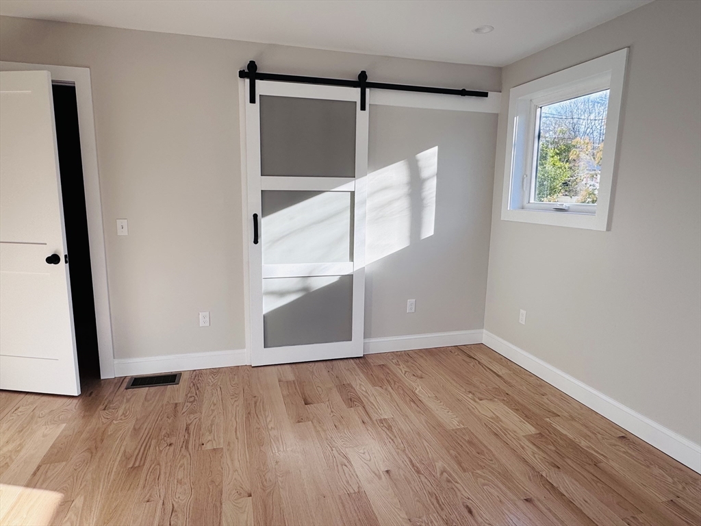 329 Tickle Road Westport, MA 02790 - Photo 25 of 42 an empty room with wooden floor and window