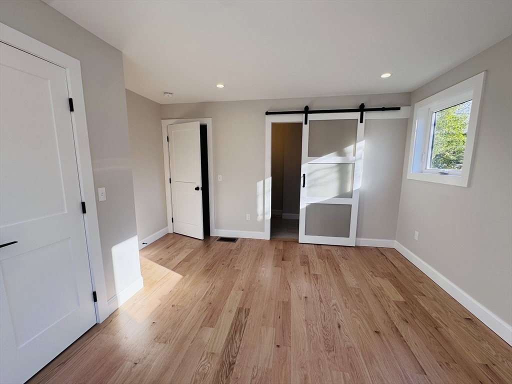 329 Tickle Road Westport, MA 02790 - Photo 27 of 42 a view of an empty room with wooden floor and a window