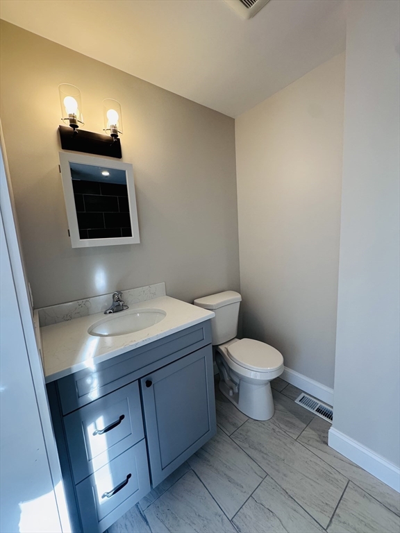 329 Tickle Road Westport, MA 02790 - Photo 29 of 42 a bathroom with a toilet sink and mirror