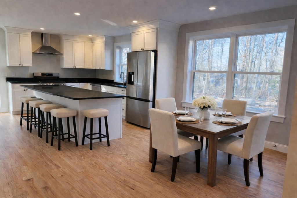 329 Tickle Road Westport, MA 02790 - Photo 3 of 42 a kitchen with stainless steel appliances granite countertop a table chairs sink and cabinets