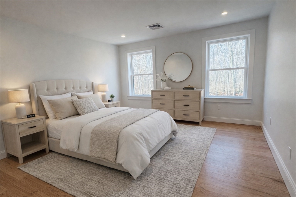 329 Tickle Road Westport, MA 02790 - Photo 32 of 42 a large bed sitting in a bedroom next to a window and a mirror