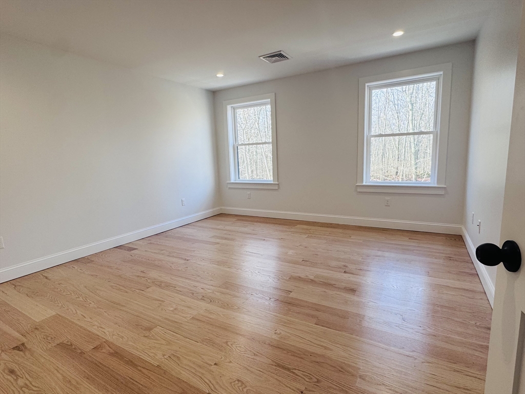 329 Tickle Road Westport, MA 02790 - Photo 33 of 42 an empty room with wooden floor and windows