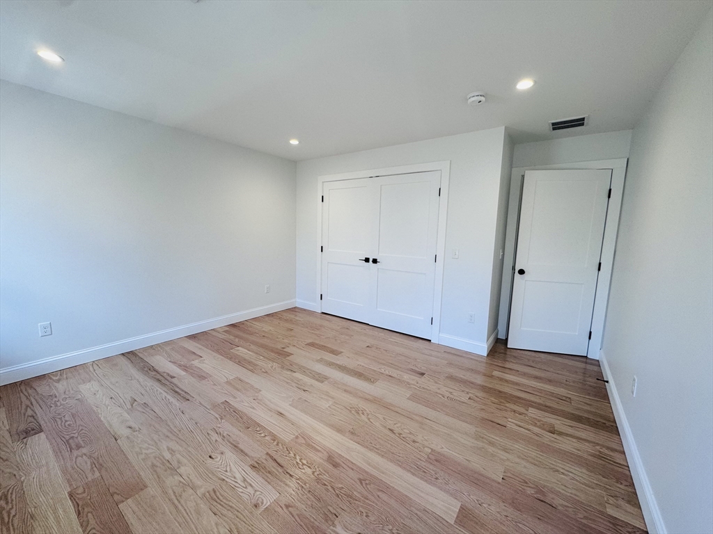 329 Tickle Road Westport, MA 02790 - Photo 36 of 42 a view of an empty room with wooden floor