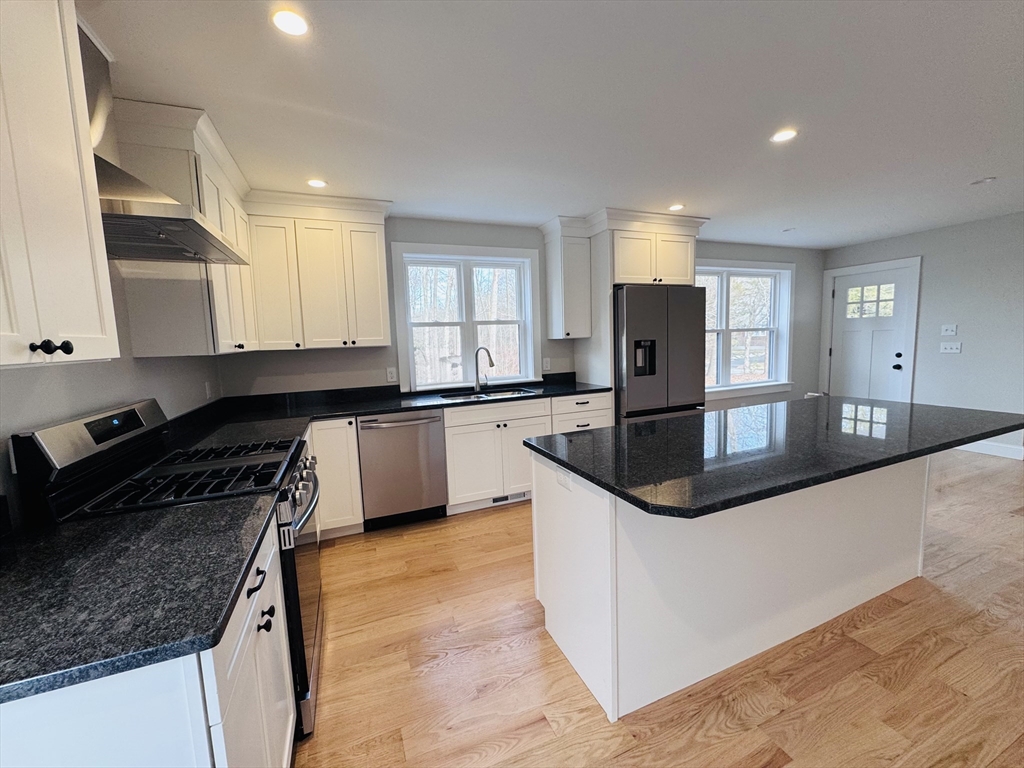 329 Tickle Road Westport, MA 02790 - Photo 5 of 42 a kitchen with granite countertop a sink and white cabinets