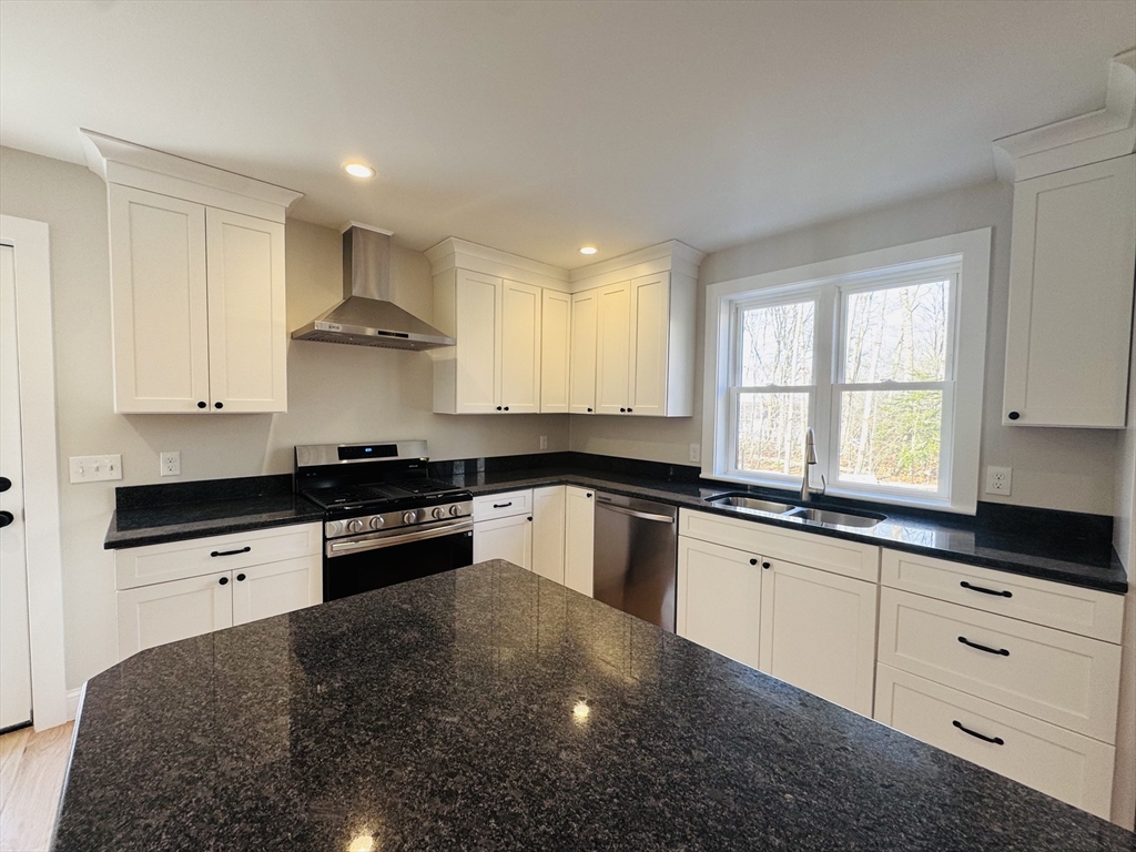 329 Tickle Road Westport, MA 02790 - Photo 6 of 42 a kitchen with granite countertop white cabinets and white appliances