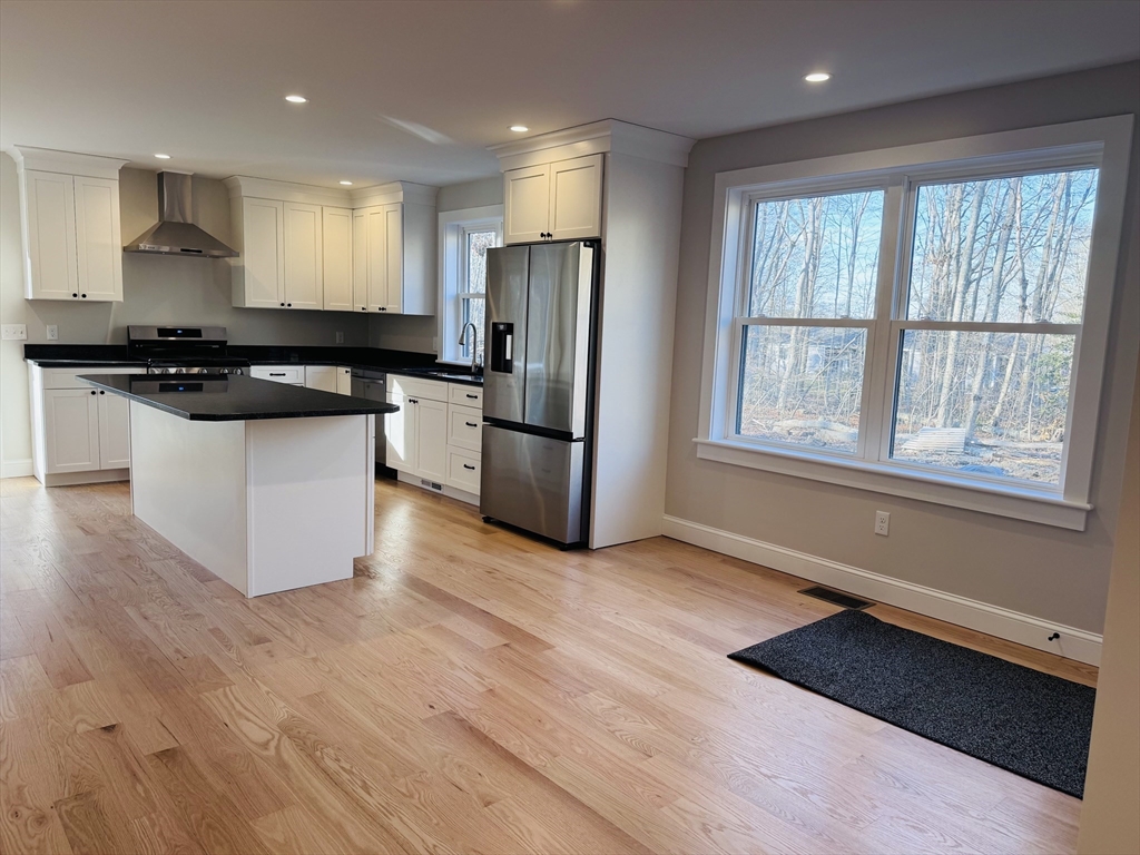 329 Tickle Road Westport, MA 02790 - Photo 7 of 42 a kitchen with stainless steel appliances granite countertop a stove a refrigerator and a microwave
