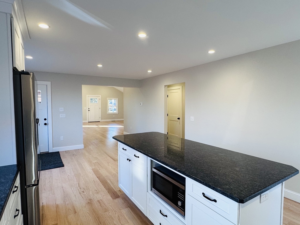 329 Tickle Road Westport, MA 02790 - Photo 10 of 42 a kitchen with stainless steel appliances granite countertop a sink and a stove