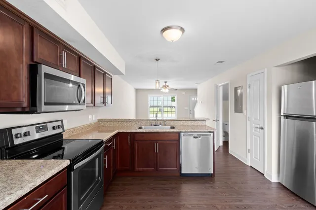 a kitchen with a sink stove and refrigerator