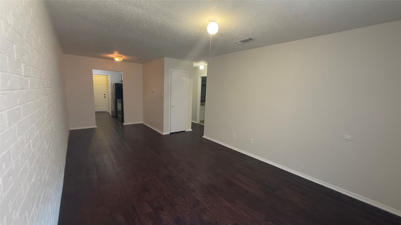 8210 Sam Rayburn Drive, Unit 103 Austin, TX 78753 - Photo 1 of 16 an empty room with wooden floor and windows