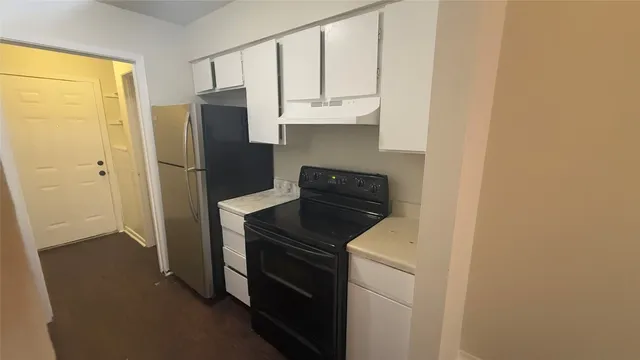 a kitchen with a refrigerator stove and microwave