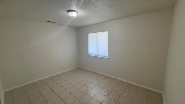 an empty room with white cabinet
