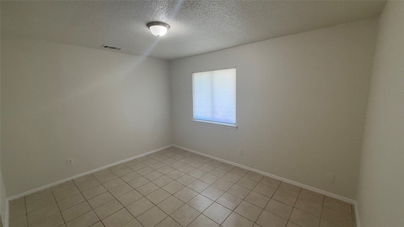 8210 Sam Rayburn Drive, Unit 103 Austin, TX 78753 - Photo 4 of 16 an empty room with white cabinet