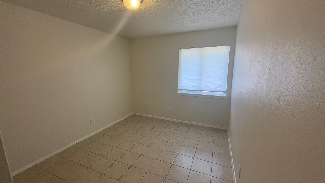 8210 Sam Rayburn Drive, Unit 103 Austin, TX 78753 - Photo 6 of 16 an empty room with a window