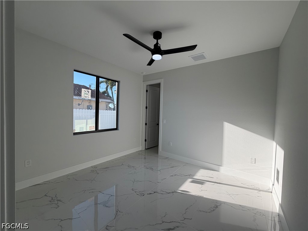 112 Northeast 6th Street Cape Coral, FL 33909 - Photo 16 of 37 an empty room with windows and ceiling fan