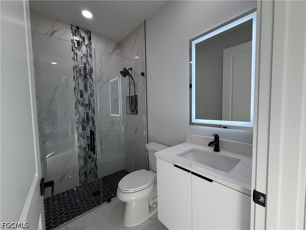 112 Northeast 6th Street Cape Coral, FL 33909 - Photo 17 of 37 a bathroom with a sink toilet and shower