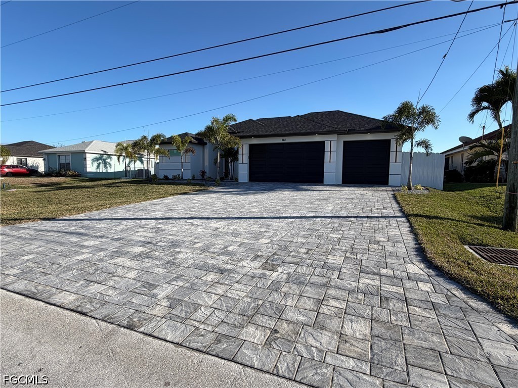 112 Northeast 6th Street Cape Coral, FL 33909 - Photo 2 of 37 a front view of a house with a yard