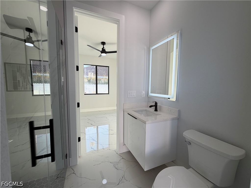 112 Northeast 6th Street Cape Coral, FL 33909 - Photo 23 of 37 a bathroom with a toilet sink and mirror