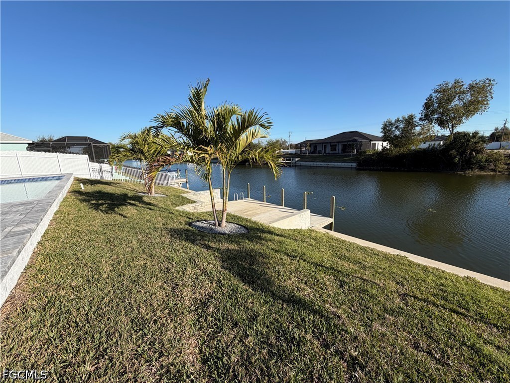 112 Northeast 6th Street Cape Coral, FL 33909 - Photo 32 of 37 a view of a lake with a house in the background