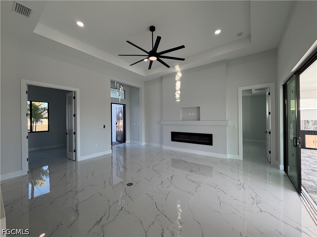 112 Northeast 6th Street Cape Coral, FL 33909 - Photo 8 of 37 a view of a livingroom with a chandelier fan and windows