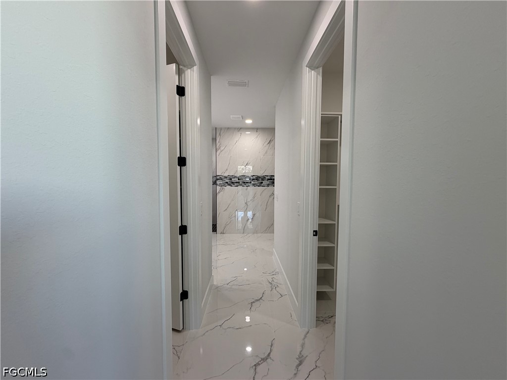 112 Northeast 6th Street Cape Coral, FL 33909 - Photo 10 of 37 a bathroom with a glass shower door