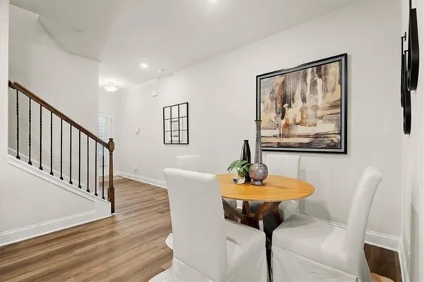 a dining room with furniture and wooden floor