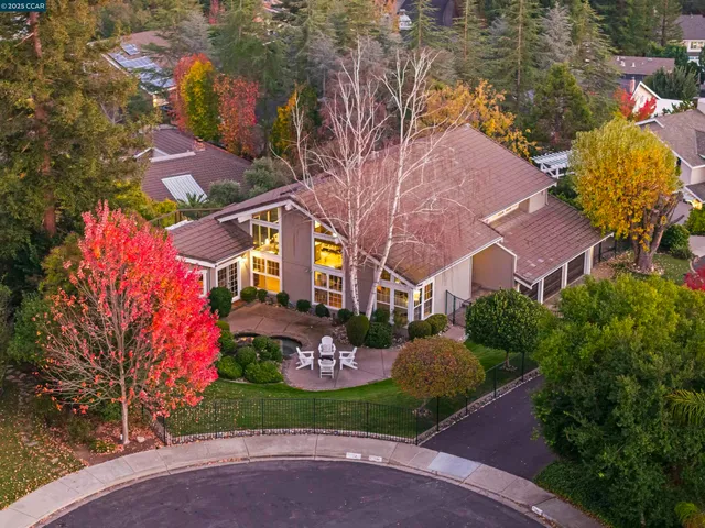 a view of a house with a yard and garden