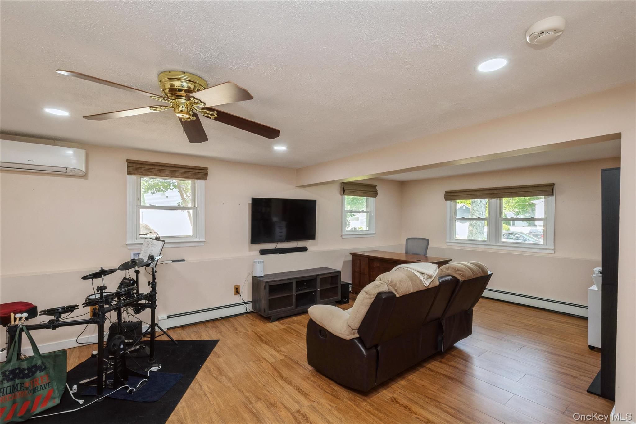 115 Clarendon Road Ronkonkoma, NY 11779 - Photo 19 of 45 Spacious room featuring laminated flooring, recessed lighting, and multiple windows