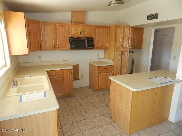 2007 West Saxony Road Tucson, AZ 85713 - Photo 8 of 25 a kitchen with a sink a stove and a refrigerator
