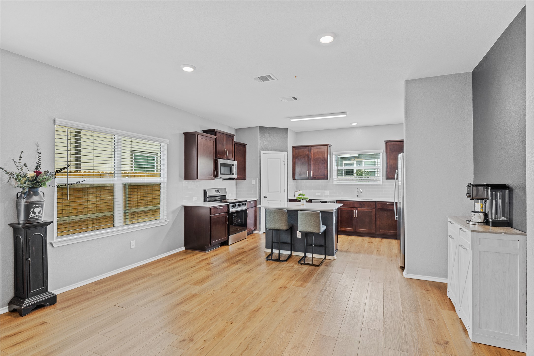 425 Perfect World Loop Jarrell, TX 76537 - Photo 6 of 29 Open-concept living space with light wood-finish flooring