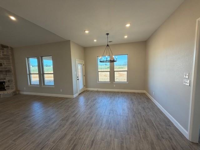 230 Kilkenny Road Poolville, TX 76487 - Photo 8 of 22 an empty room with wooden floor and windows