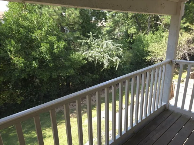 a view of a balcony with wooden floor