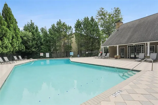 a view of house with swimming pool