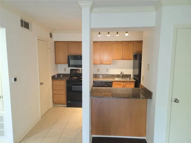 a kitchen with a refrigerator and a stove