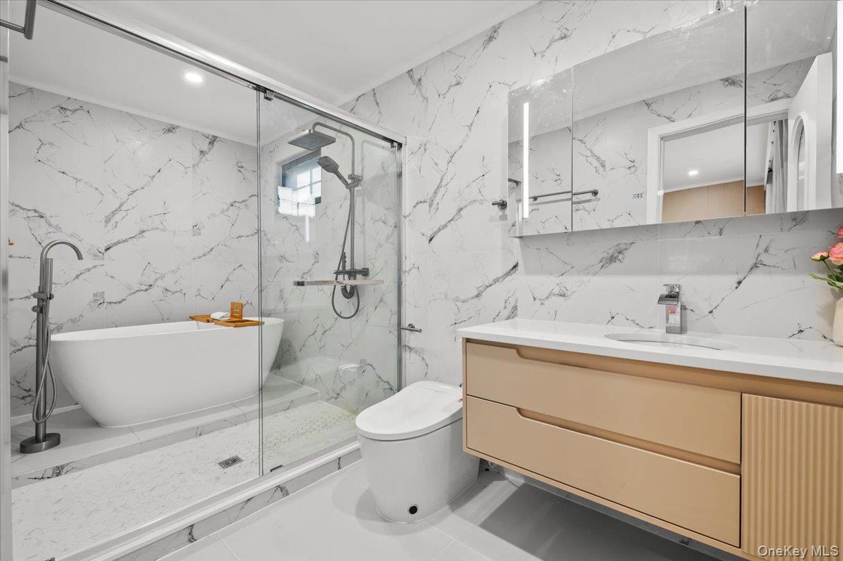 2 Elf Road Syosset, NY 11791 - Photo 15 of 38 a bathroom with a sink a toilet and shower