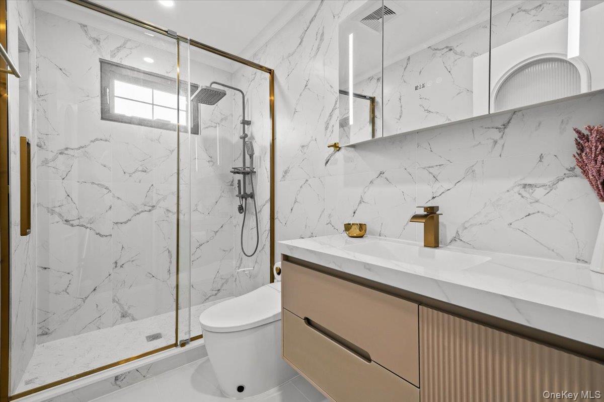 2 Elf Road Syosset, NY 11791 - Photo 17 of 38 a bathroom with a granite countertop sink a toilet and shower