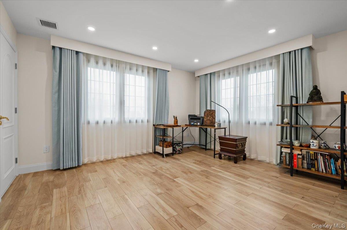 2 Elf Road Syosset, NY 11791 - Photo 20 of 38 a room with gym equipment and a large window