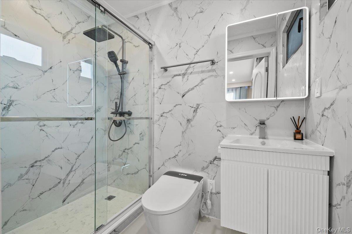 2 Elf Road Syosset, NY 11791 - Photo 21 of 38 a bathroom with a granite countertop sink toilet and shower