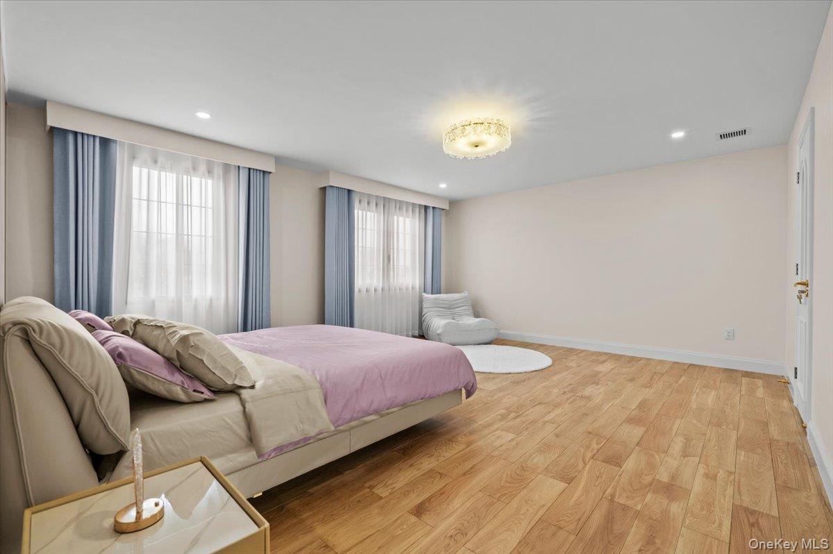 2 Elf Road Syosset, NY 11791 - Photo 22 of 38 a bedroom with a bed and a window