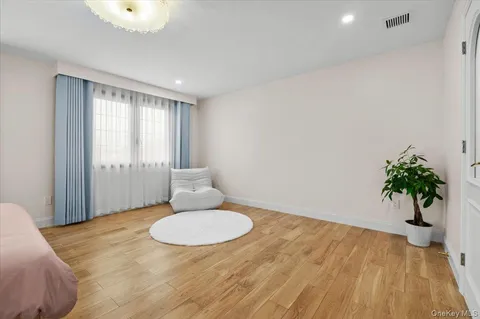 a front view of a house with a yard and trees