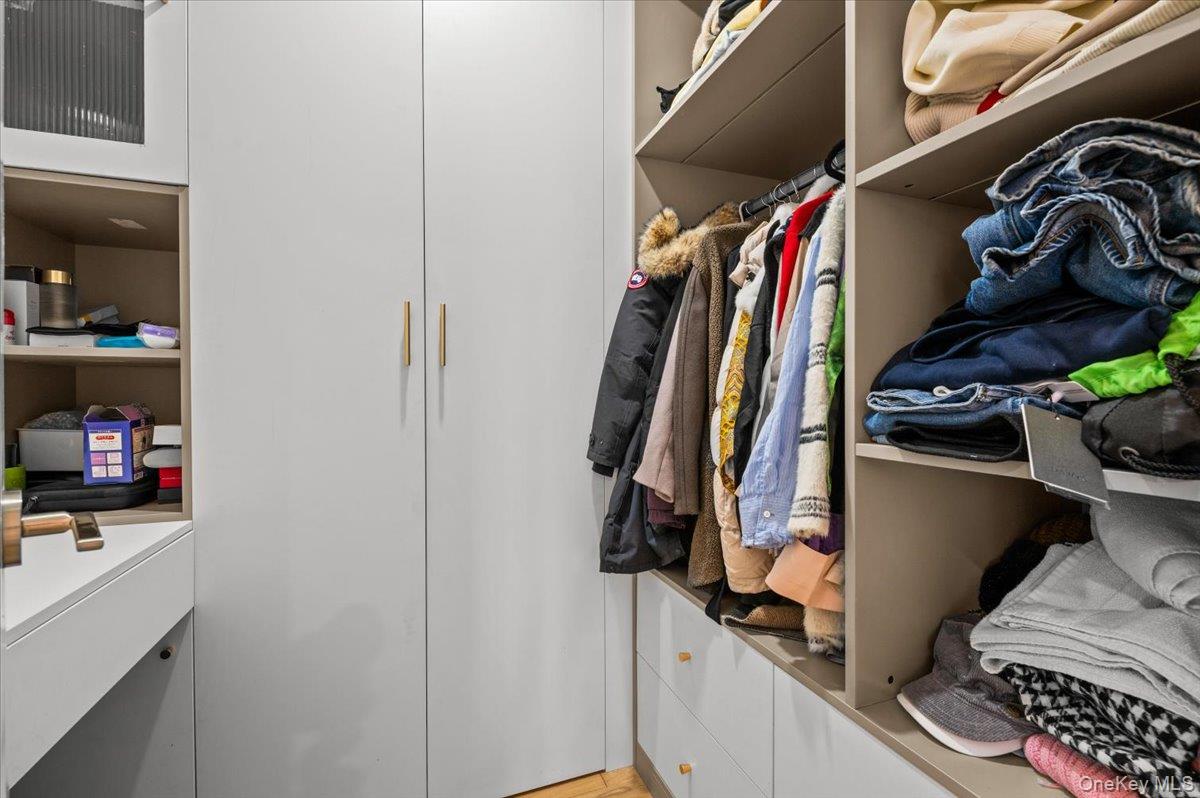 2 Elf Road Syosset, NY 11791 - Photo 25 of 38 a view of walk in closet with clothes and shoes