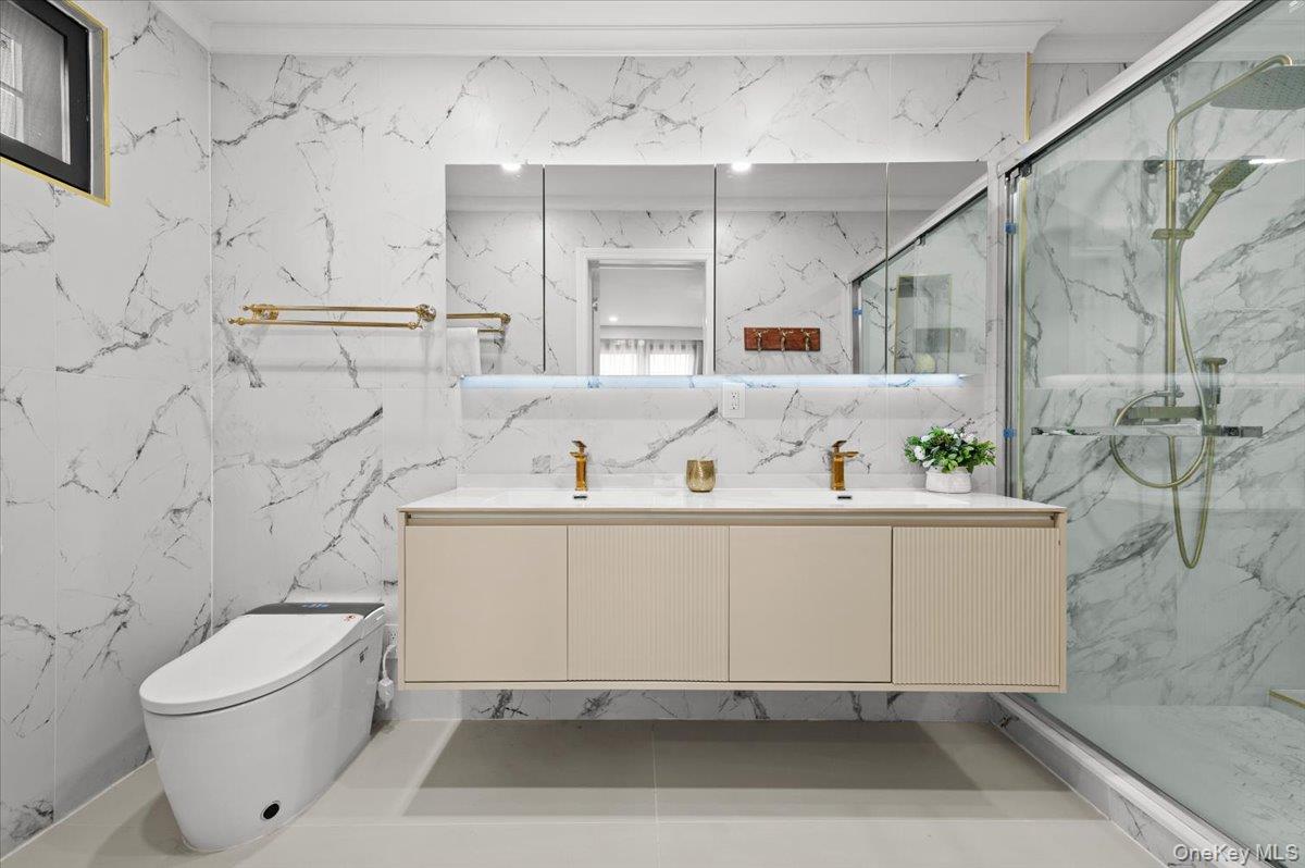 2 Elf Road Syosset, NY 11791 - Photo 28 of 38 a bathroom with a sink a toilet and shower