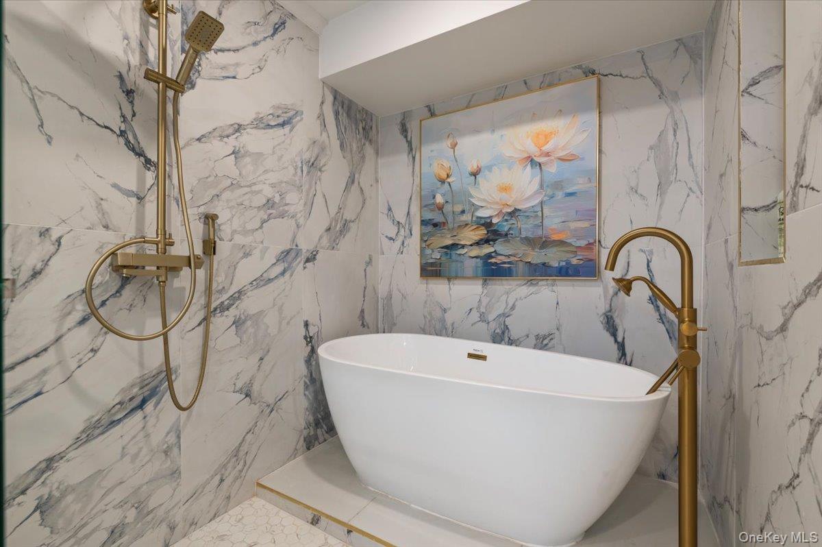 2 Elf Road Syosset, NY 11791 - Photo 29 of 38 a white bath tub sitting next to a shower