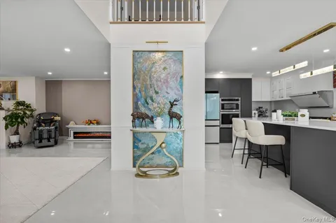 a living room with furniture and a painting on the wall