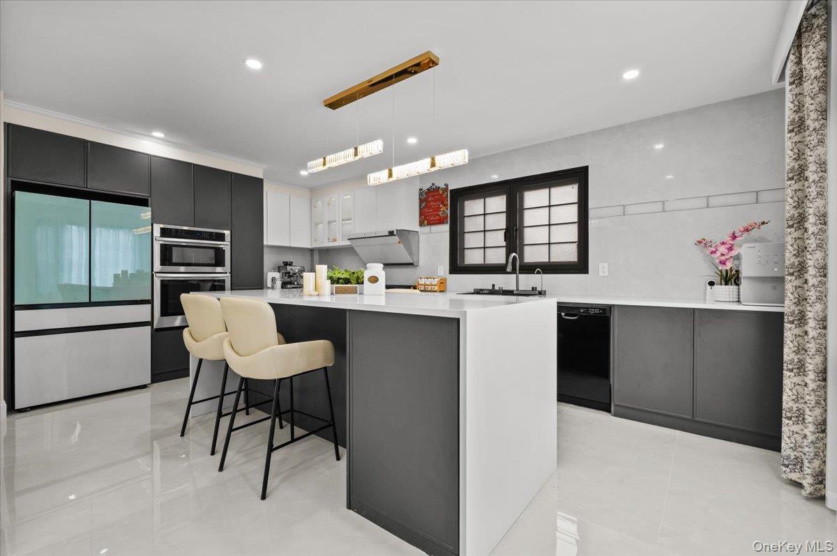 2 Elf Road Syosset, NY 11791 - Photo 5 of 38 a kitchen with counter top space cabinets and stainless steel appliances
