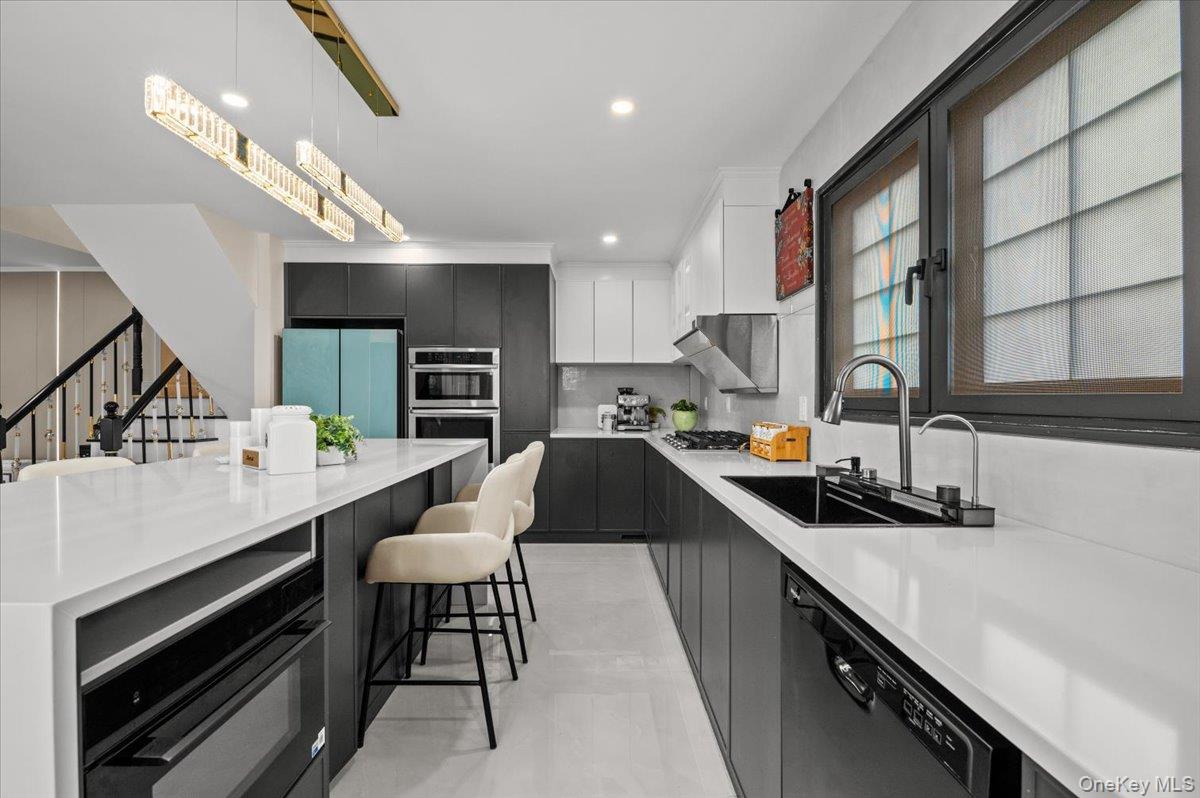 2 Elf Road Syosset, NY 11791 - Photo 6 of 38 a kitchen with counter top space cabinets and stainless steel appliances